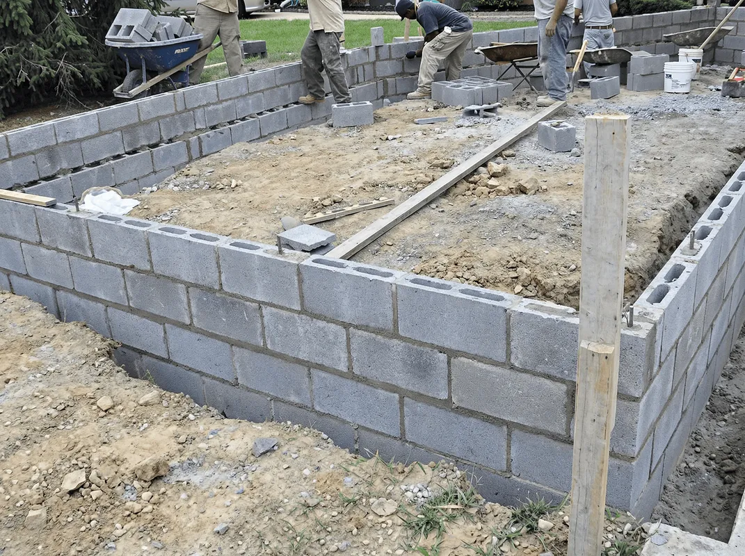 Professionals building a foundation with blocks in Denver, CO